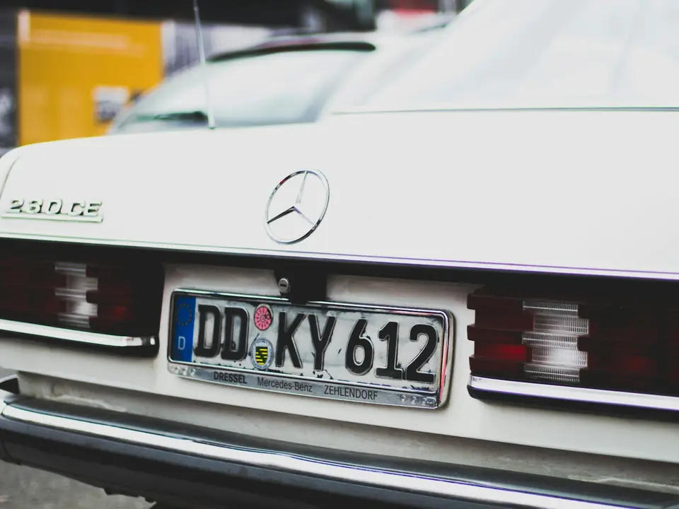 Rear of a white car with its licence plate readable